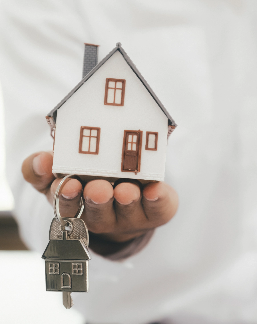 man holding a small house
